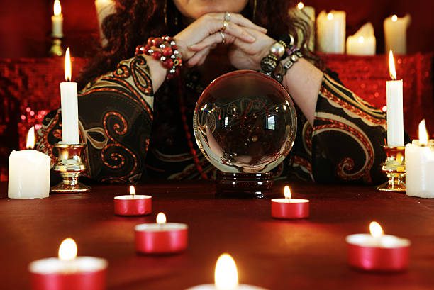 fortune teller, candles and crystal ball - vidente fotografías e imágenes de stock