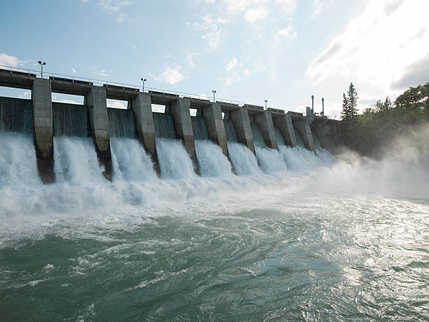 hydroelectric dam during spring runoff, full water - presa fotografías e imágenes de stock